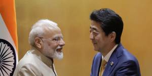 India’s Prime Minister Narendra Modi shakes hands with Japan’s former leader Shinzo Abe in 2019.