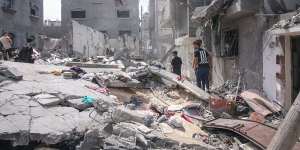 Palestinians inspect the rubble of a building after an Israeli airstrike in central Gaza last month.