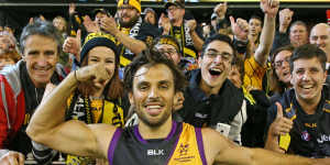 MELBOURNE,VICTORIA - MAY 14:Sam Lloyd of the Tigers celebrates with Tigers supporters in the crowd after kicking the match-winning goal after the final siren during the round eight AFL match between the Richmond Tigers and the Sydney Swans at the Melbourne Cricket Ground on May 14,2016 in Melbourne,Australia. (Photo by Scott Barbour/AFL Media/Getty Images)