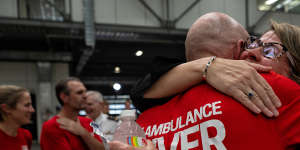 NSW Health Secretary Susan Pearce hugs a paramedic at Randwick Ambulance station after the announcement.