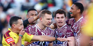 Manly congratulate Tom Trbojevic after one of his three tries.