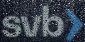 A sign to Silicon Valley Bank is seen through raindrops on a window in Santa Clara,California.