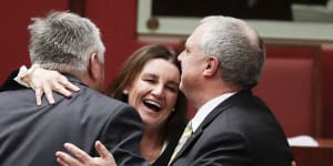 Crossbench senators Rex Patrick,Jacqui Lambie and Stirling Griff celebrate after the passage of the bill.