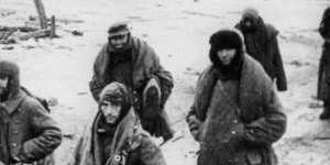 Misery ... captured German soldiers make their way through the ruins of Stalingrad.