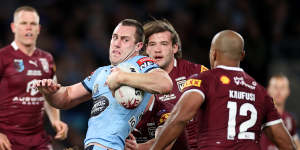 Isaah Yeo is tackled by the Queensland defence.