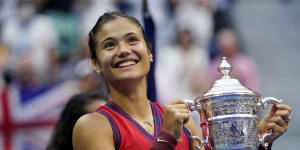 Emma Raducanu of Britain holds up the US Open championship trophy after defeating Leylah Fernandez of Canada.