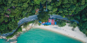 This tropical garden oasis faces a picturesque white-sand beach.