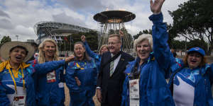 AOC President John Coates in 2020 with volunteers at the Lighting of the Cauldron,celebrating the 20-year anniversary of the opening of the Sydney 2000 Olympic and Paralympic Games.