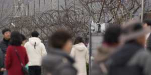 Visitors near the wire fence that devides the two countries,at the Imjingak Pavilion in Paju,South Korea.
