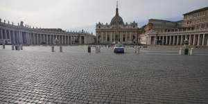 A police car is parked inside an empty St Peter's Square as Italy entered a nationwide lockdown on Thursday.