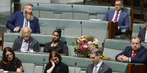 A bouquet of flowers is placed on the desk of Peta Murphy,as Labor MP Lisa Chesters wipes her eyes during the condolence motion.