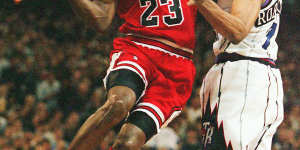 Michael Jordan takes flight against Toronto's Alvin Robertson in 1996.