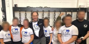 Powerlifting Australia’s national coaching director Robert Wilks,centre,has launched defamation proceedings against once of his female students. 