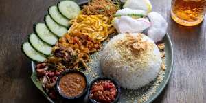 Nasi uduk - an Indonesian spin on the Nasi Lemak - with fried rice noodles,shredded chicken,crunchy anchovies and peanuts,fried chilli potato,spiced omelette,cucumber,crackers,peanut sauce,sambal,coconut rice and fried shallots.