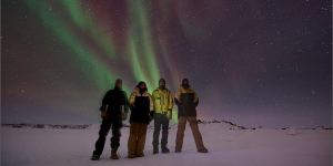 Knoff (far right) with colleagues in Antarctica. “Winter field trip under the southern lights,temperature around minus 20 degrees hence every layer of clothing required!” 