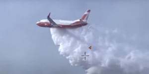 Rain'taken sting out'of Fraser Island fire,NSW water-bomber goes home