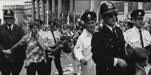 Police remove demonstrators from the roadway outside the Art Gallery on October 22,1966.