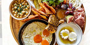 Breakfast board loaded with fried eggs,ful medames,zaatar manoush,labneh,cold-cuts,assorted pickles,fresh vegies and village cheeses.