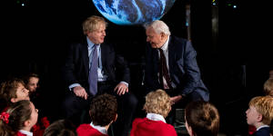 British Prime Minister Boris Johnson and British broadcaster and naturalist Sir David Attenborough speak with schoolchildren during the launch of the UK-hosted COP26 UN Climate Summit in Glasgow.