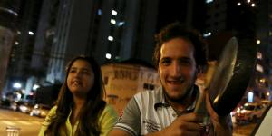 A man hits pans at a Sao Paulo bar in protest against the speech of Brazilian President Dilma Rousseff,broadcast on television.