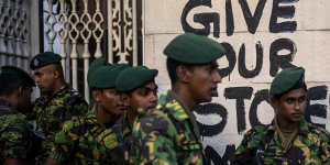 Sri Lankan soldiers patrol near the official residence of president Gotabaya Rajapaksa.