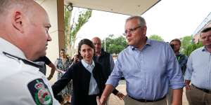 Prime Minister Scott Morrison and NSW Premier Gladys Berejiklian with RFS Commissioner Shane Fitzsimmons arriving on Sunday at the Picton Bowling Club,which is being used as a evacuation centre.
