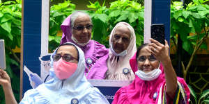 Women in Mumbai take post-vaccination selfies outside a hospital in March.