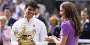 Carlos Alcaraz smiles after receiving his trophy from the Princess of Wales.