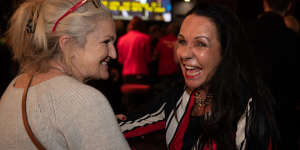 Linda Burney greets Labor Party supporters as they watch the election count on Saturday night.