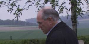 John Howard views graves at Tincourt-Boucly on the Western Front in April 2000.