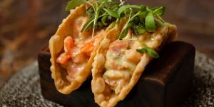 Confit salmon tacos with house-made shells filled with a bright mix of fish,herbs and jalapeno dressing. 