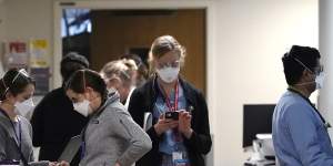 Medical workers fill a hallway in the acute care unit,where about half the patients are COVID-19 positive or in quarantine after exposure,of Harborview Medical Centre in Seattle.