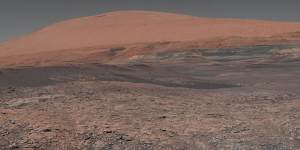 Welcome to Mars,where Mount Sharp rises in the distance. In the middle ground are clay-bearing rocks that scientists hope will help ascertain the role of water on the planet.
