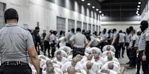 A prison guard transfers deportees from the US,alleged to be Venezuelan gang members,to the Terrorism Confinement Centre in Tecoluca,El Salvador.