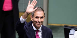 Treasurer Dr Jim Chalmers waves towards people in the public galleries after the Budget speech.