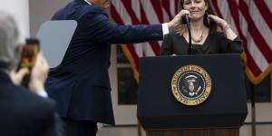 President Donald Trump adjusts the microphone as he announces Judge Amy Coney Barrett as his nominee to the Supreme Court.
