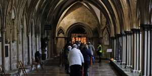 People queue for the vaccine in the cathedral’s 13th century cloisters. 