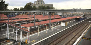 The usually bustling Redfern station lies deserted on Monday after train services were suspended.