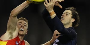 Gold Coast’s Jacob Townsend and Lachie Plowman of the Blues fly for the ball.