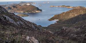 Luxury catamaran Odalisque III in Bramble Cove with the Breaksea Islands beyond. 