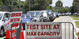 COVID-19 testing reaches capacity,as cars wait in line in Orlando,Florida. 