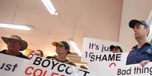 Queensland dairy farmers protesting inside a Coles supermarket last week. 