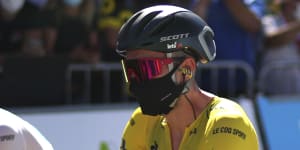 A masked Adam Yates,from Australian team Mitchelton-Scott,wears the yellow jersey as leader of the Tour de France.