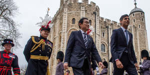 Japanese Prime Minister Fumio Kishida,centre,and Britain’s PM Rishi Sunak,right,walk through the Tower of London after signing a defence agreement.