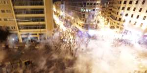 Lebanese riot police fire tear gas during a protest against government's plans to impose new taxes in Beirut,Lebanon.