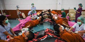 Buddhist monks donate blood for the victims.