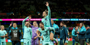 Australia players applaud fans after the team’s 4-0 victory.