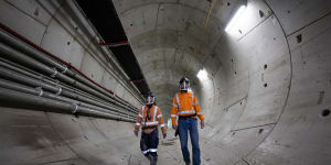 Workers in one of the rail tunnels at the site of the airport station.