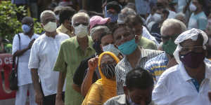 People queue in Mumbai,India,on Monday to receive their COVID-19 vaccine.