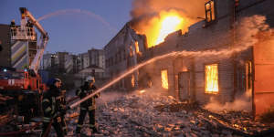 Ukrainian firefighters extinguish a blaze at a warehouse after a bombing in Kyiv,Ukraine,Thursday,March 17,2022.
